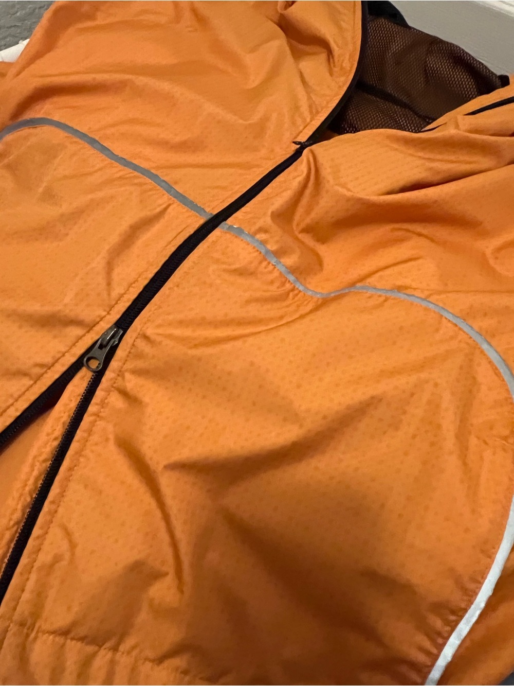 Nike Women’s Orange Lightweight Windbreaker Jacket with reflective contrast